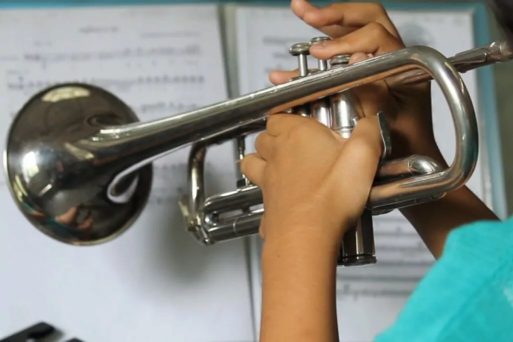 a child playing a trumpet