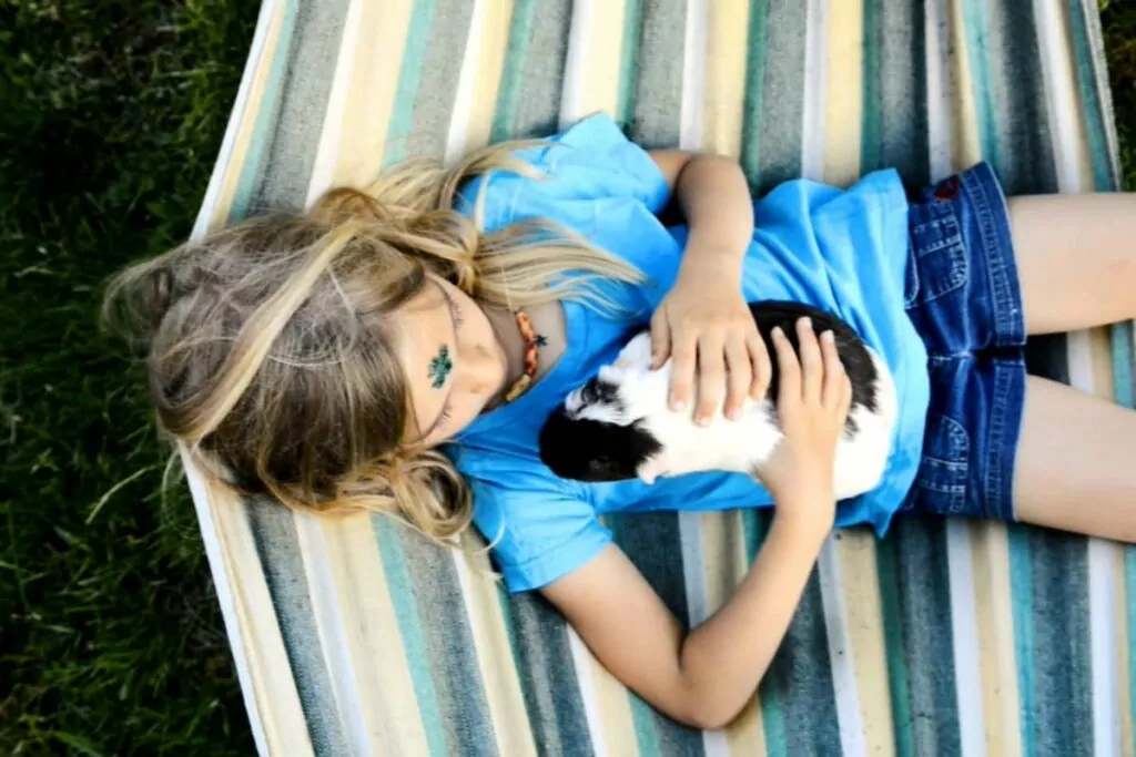 A girl petting a guinea pig