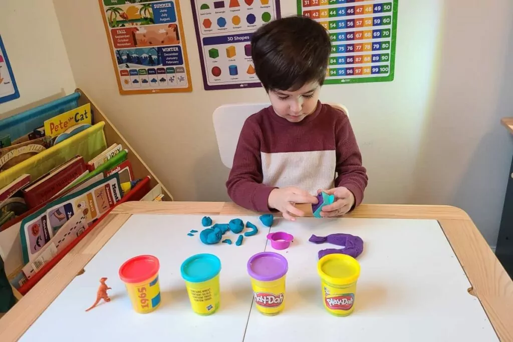 autistic child playing with play-doh